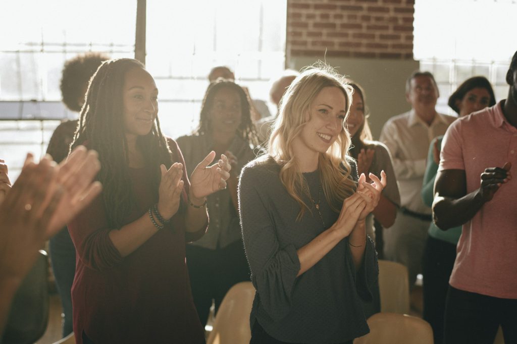 Diverse people clapping after a session