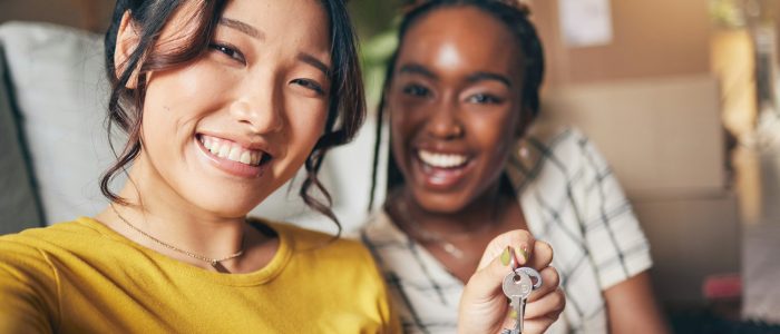 Couple of friends, keys and new home selfie for moving in together for real estate investment. Rent